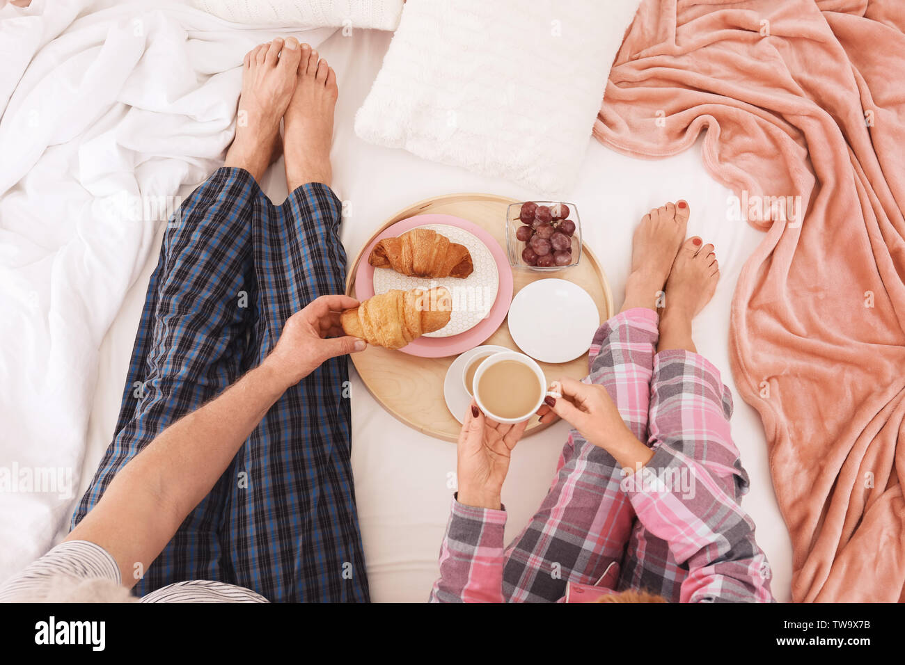 Mature couple having breakfast in bed. Romantic morning Stock Photo