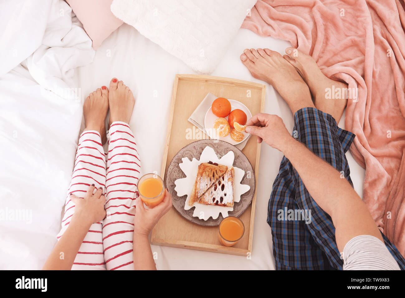 Mature couple having breakfast in bed. Romantic morning Stock Photo