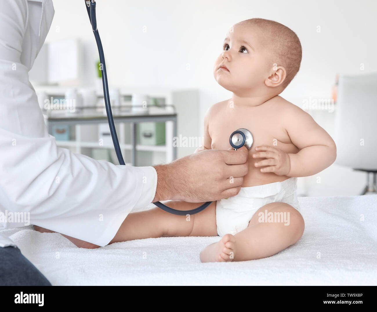 Doctor examining cute baby in clinic Stock Photo Alamy
