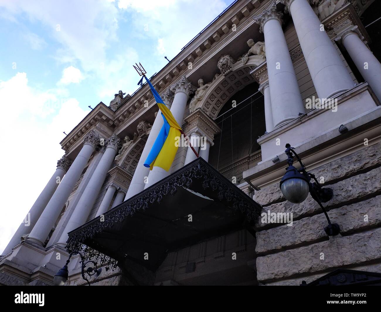 Flag of Ukraine on pole on building wall Stock Photo