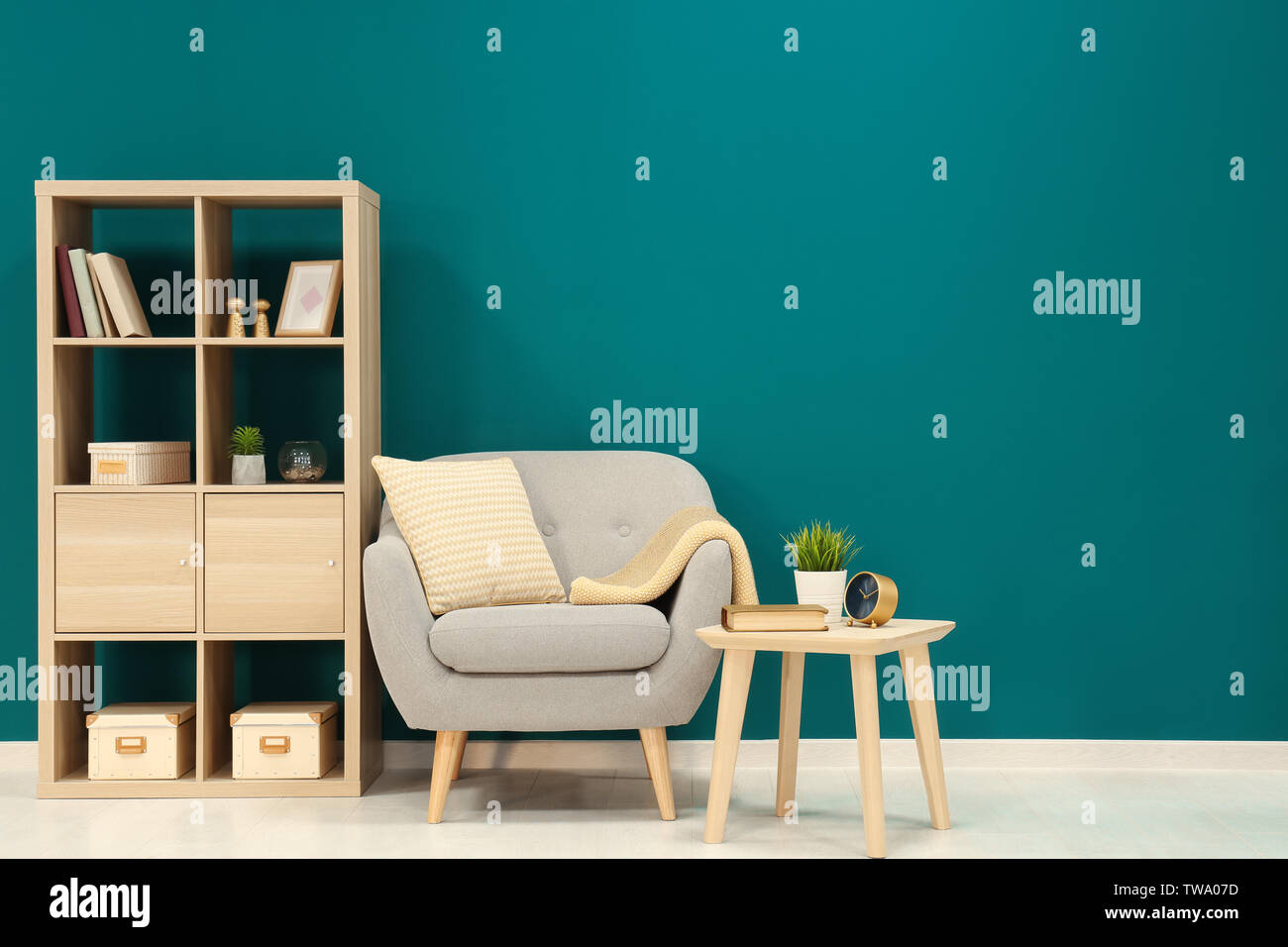 Trendy living room interior with comfortable armchair against shaded