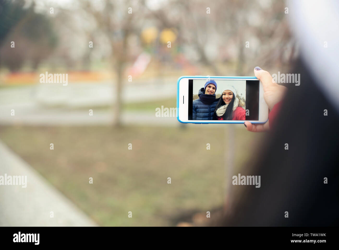 Cute couple taking selfie outdoors Stock Photo
