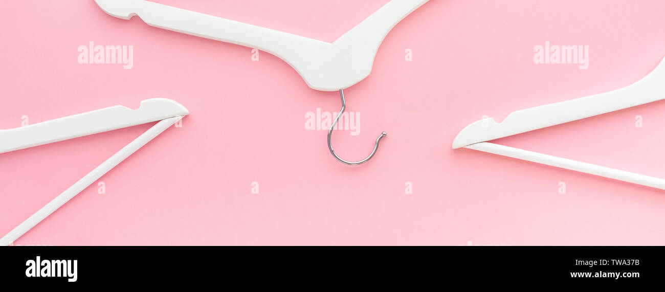 Creative top view flat lay white wooden hangers pastel millennial pink ...