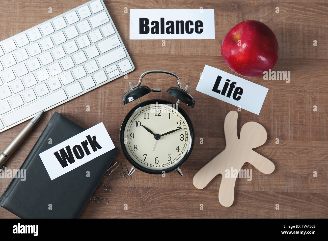 Composition with words WORK, LIFE, BALANCE and alarm clock on wooden ...