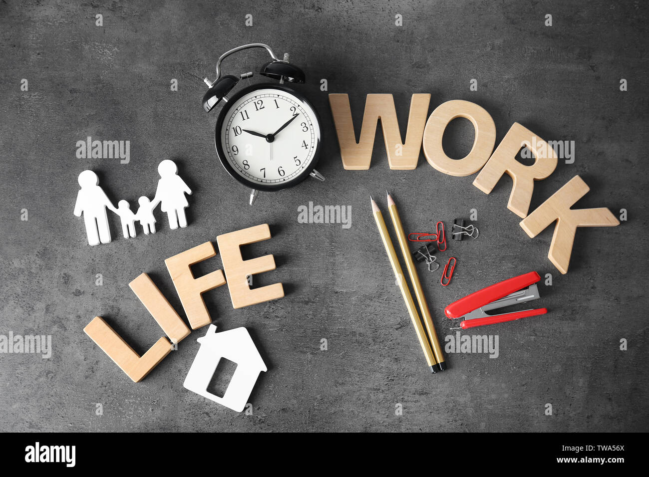Composition with words WORK, LIFE and alarm clock on grey background ...