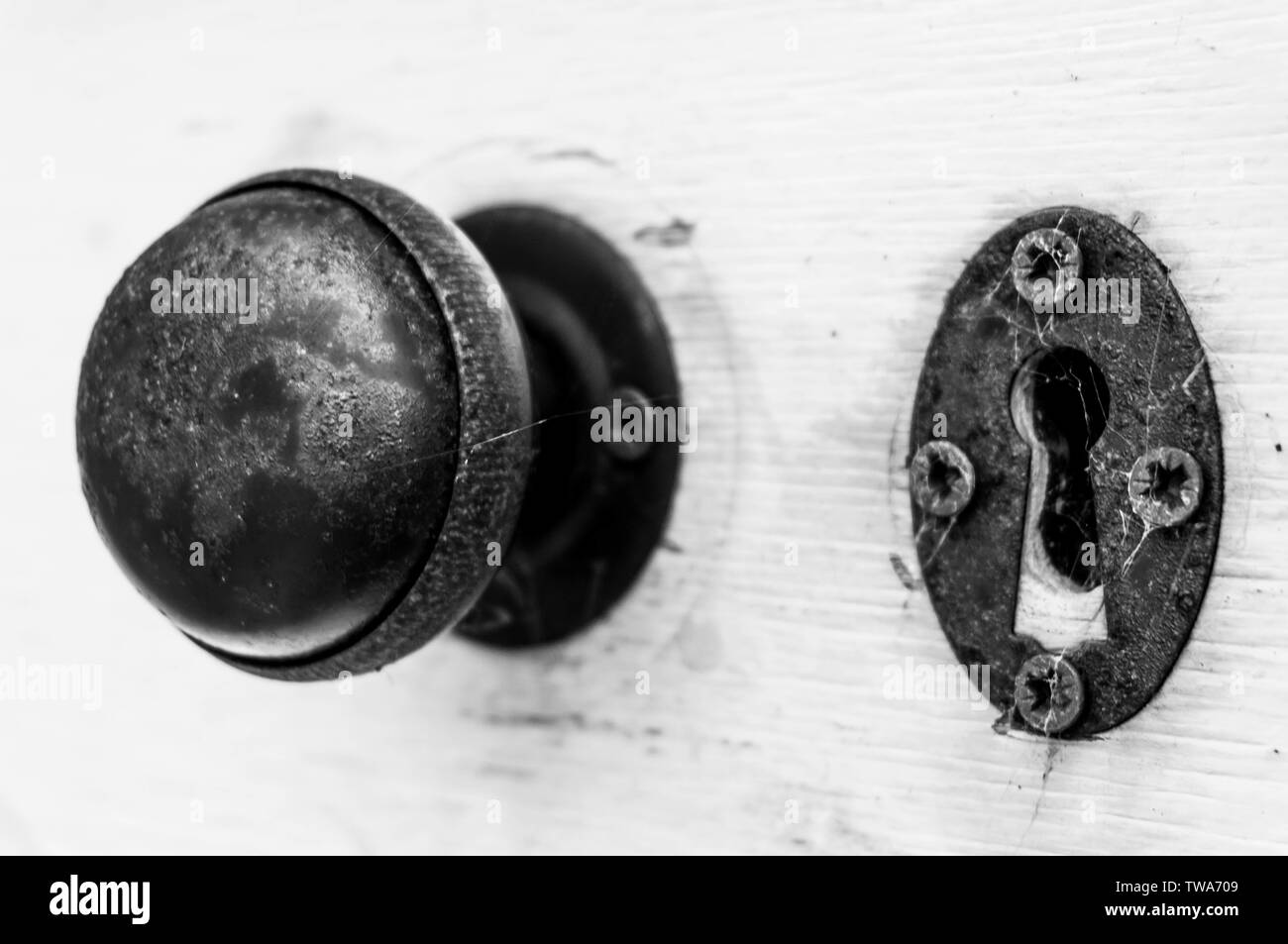 A traditional round door knob and keyhole on a wooden door Stock Photo