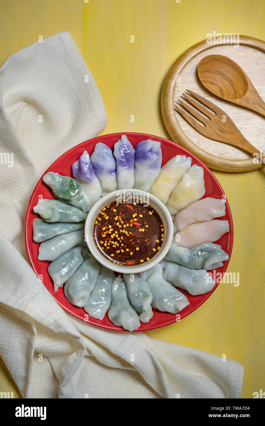 steamed chives dumplings served with spicy chili sauce , asian style
