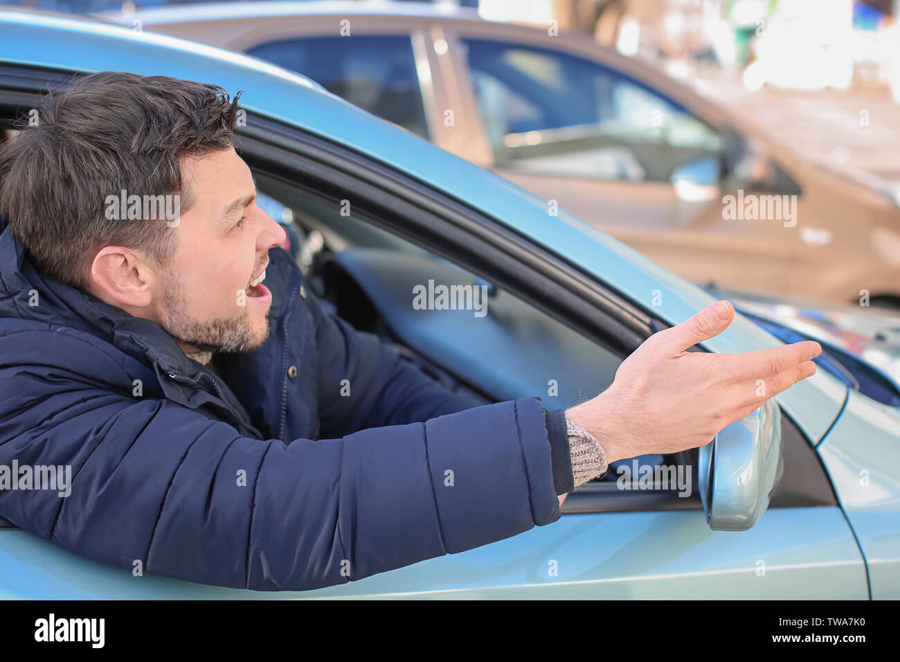 Emotional man inside car in traffic jam Stock Photo