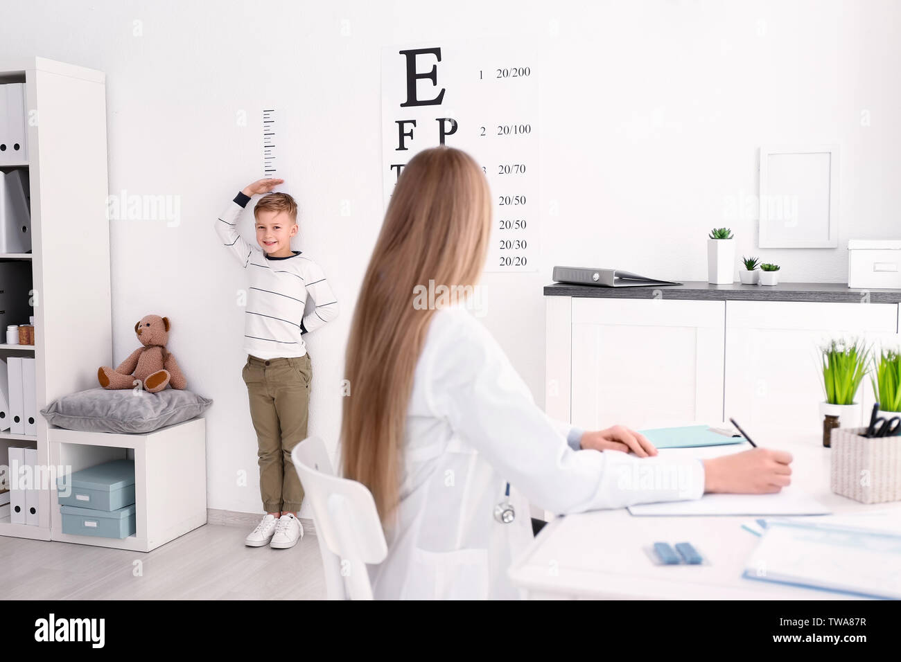 Cute little boy measuring height in hospital Stock Photo