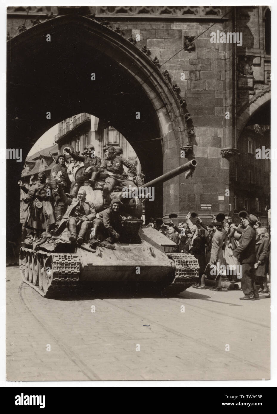 Red Army tank T-34 near the Powder Tower (Prašná brána) in Prague, Czechoslovakia, on 9 May 1945. Black and white photograph published in the Czechoslovak vintage postcard issued in 1955. Courtesy of the Azoor Postcard Collection. Stock Photo