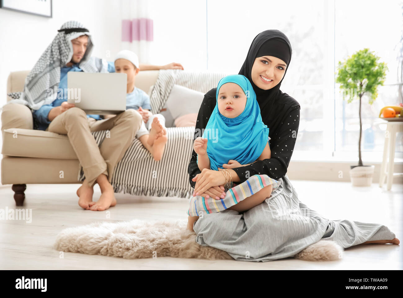 Happy Muslim family spending time together at home Stock Photo