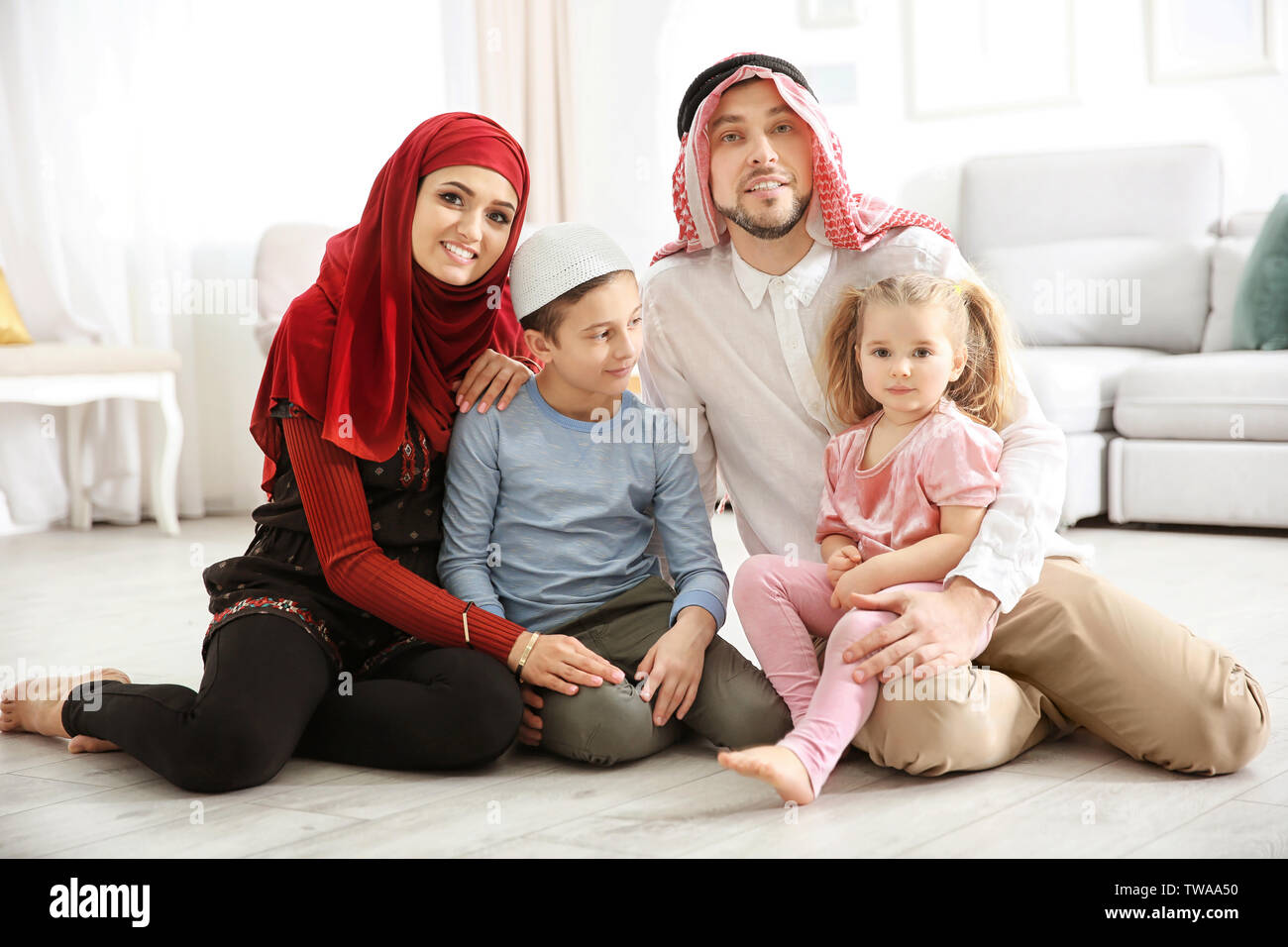 Happy Muslim family at home Stock Photo - Alamy