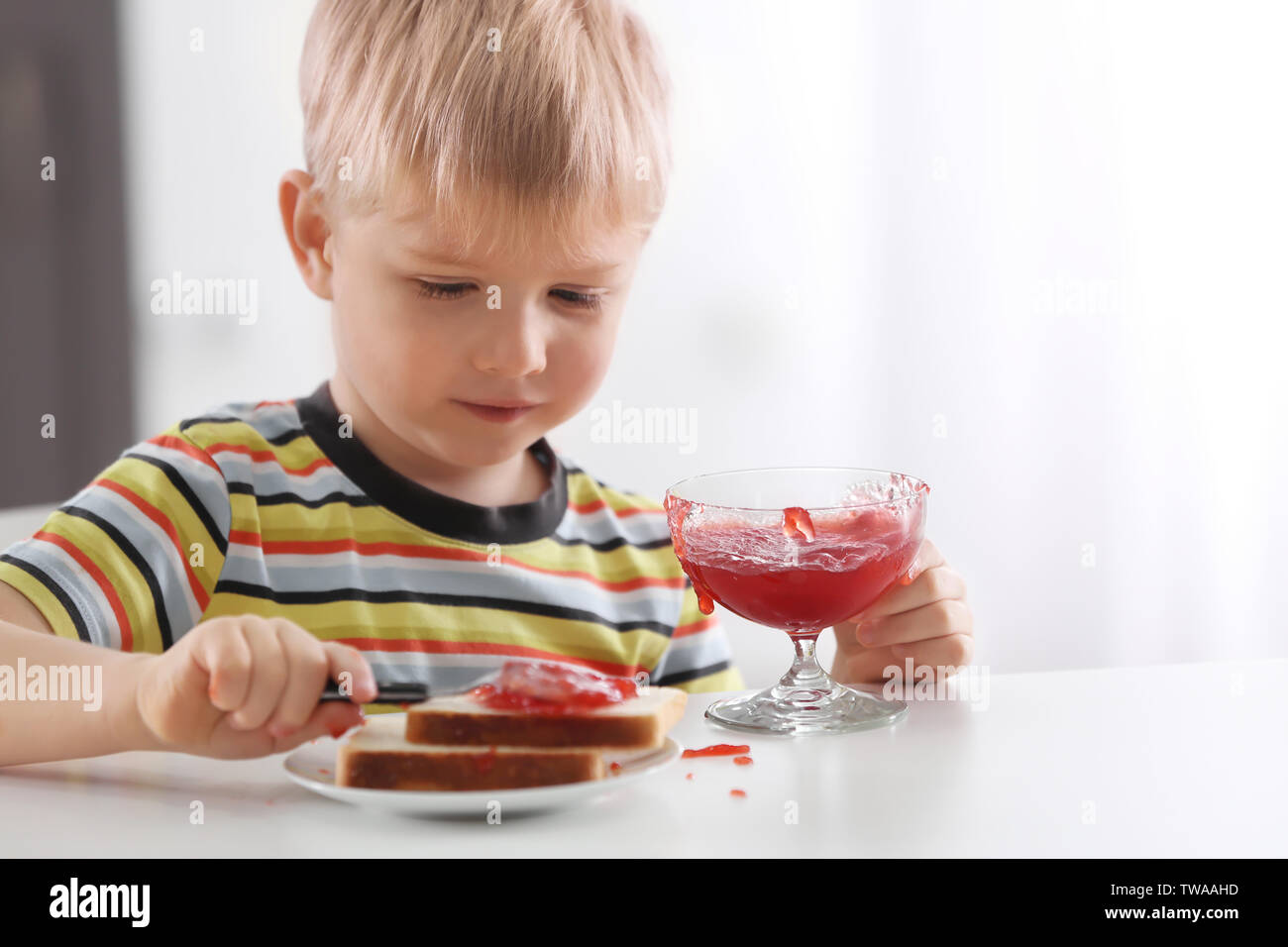 Kid eating jam on toast hires stock photography and images Alamy