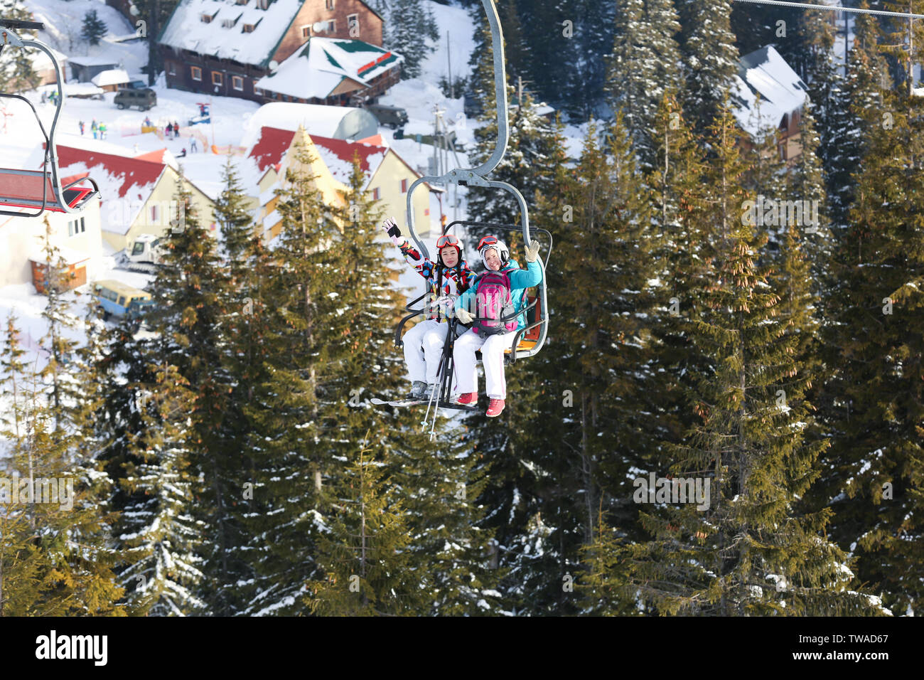 Happy friends on chair lift hi-res stock photography and images - Alamy
