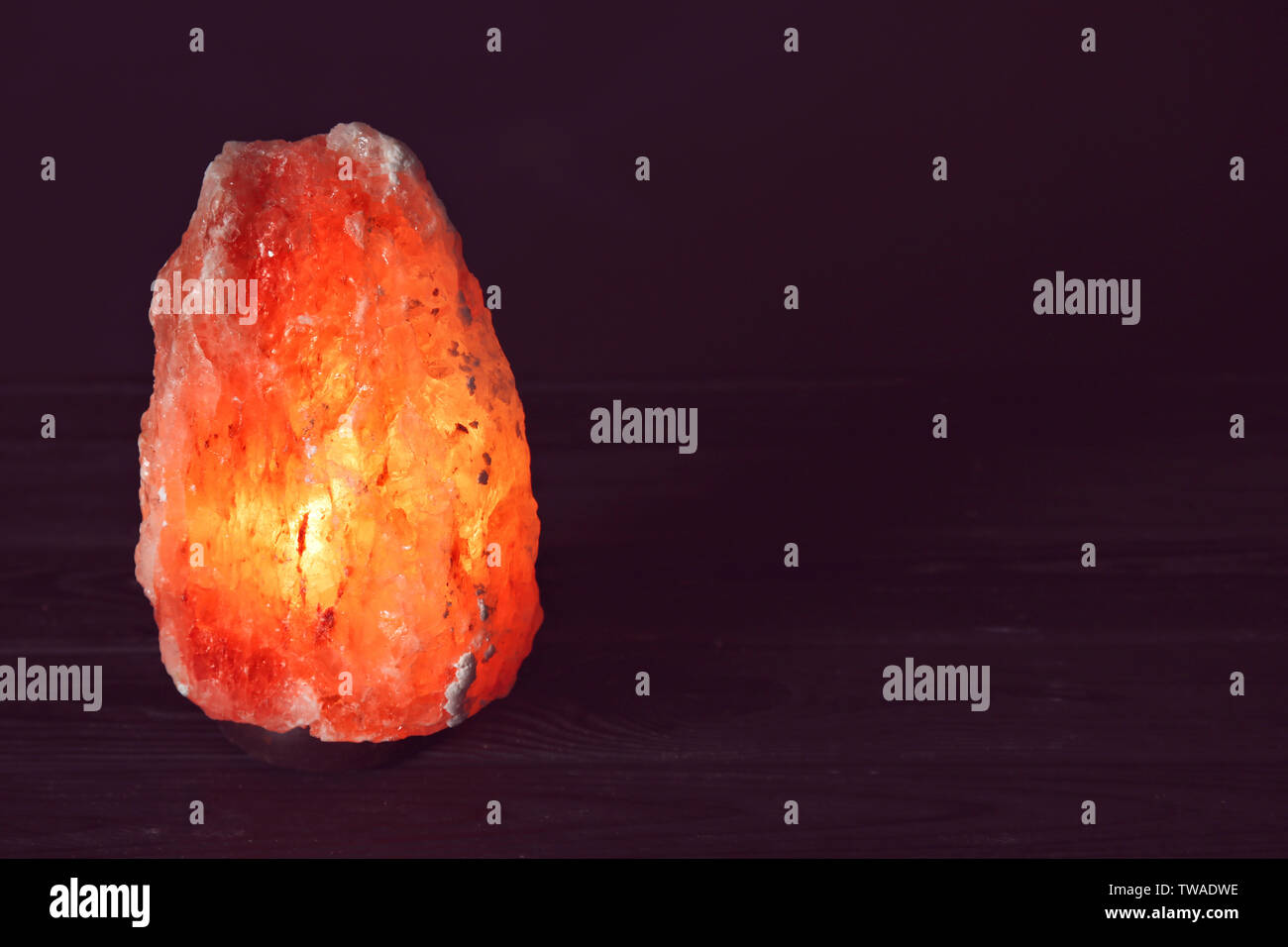 Himalayan salt lamp on black background Stock Photo