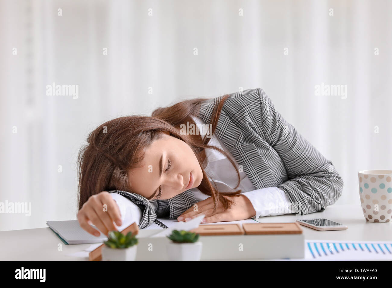 Young woman sleeping on workplace Stock Photo - Alamy