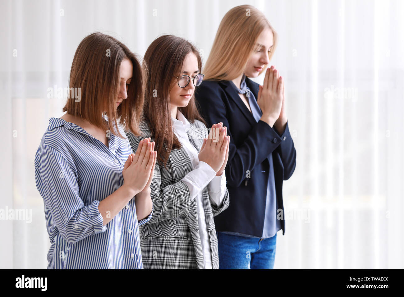 Religious women praying, indoors Stock Photo Alamy