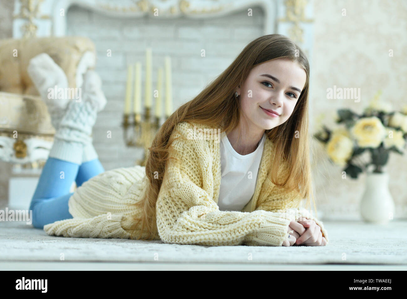 Portrait of beautiful teen girl lying on floor in room Stock Photo - Alamy