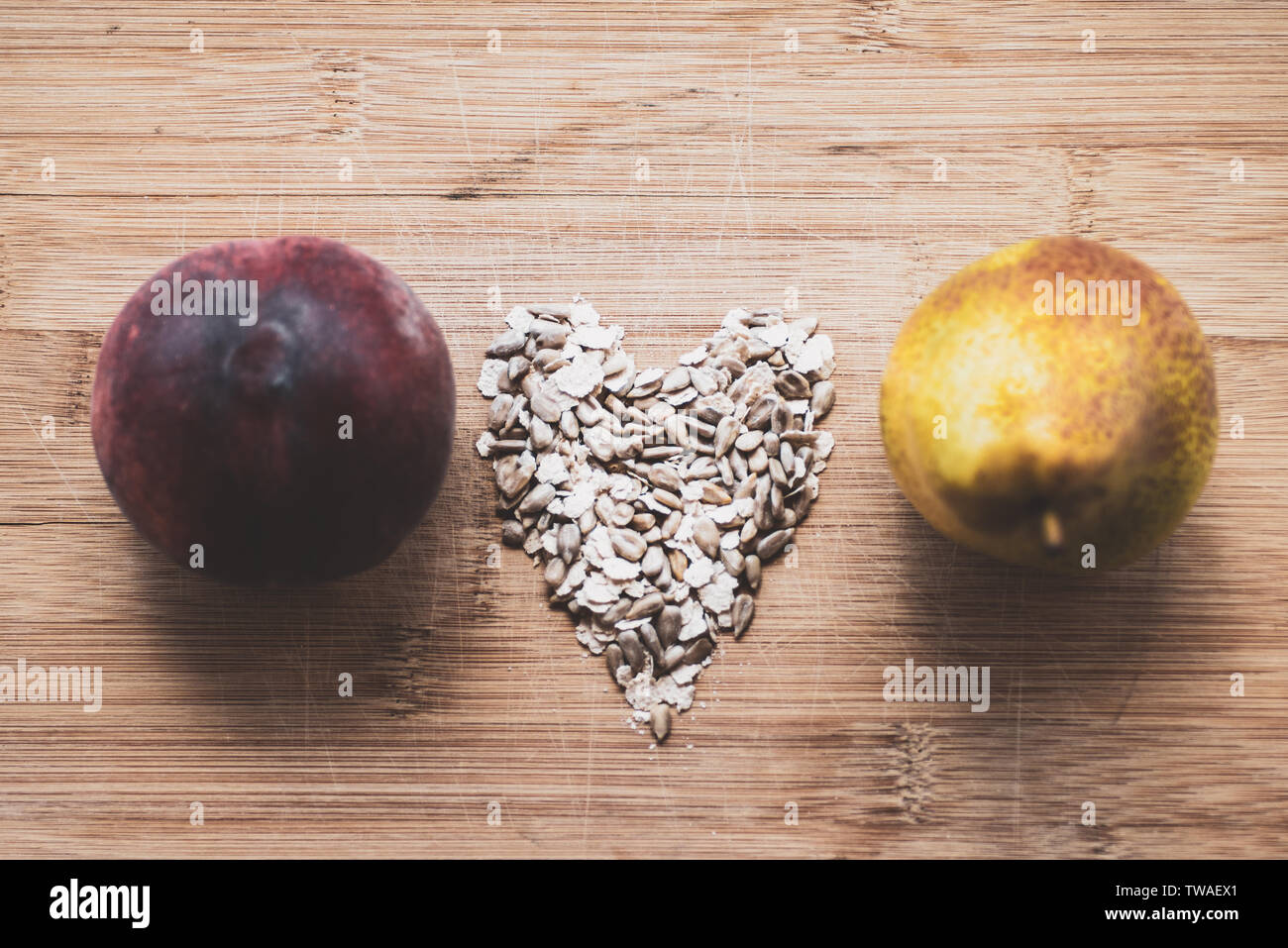 Pear, peach, oat grains, on a wooden board Stock Photo