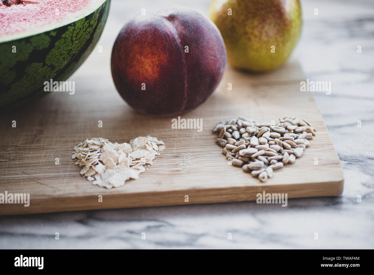Pear, peach, oat grains, on a wooden board Stock Photo