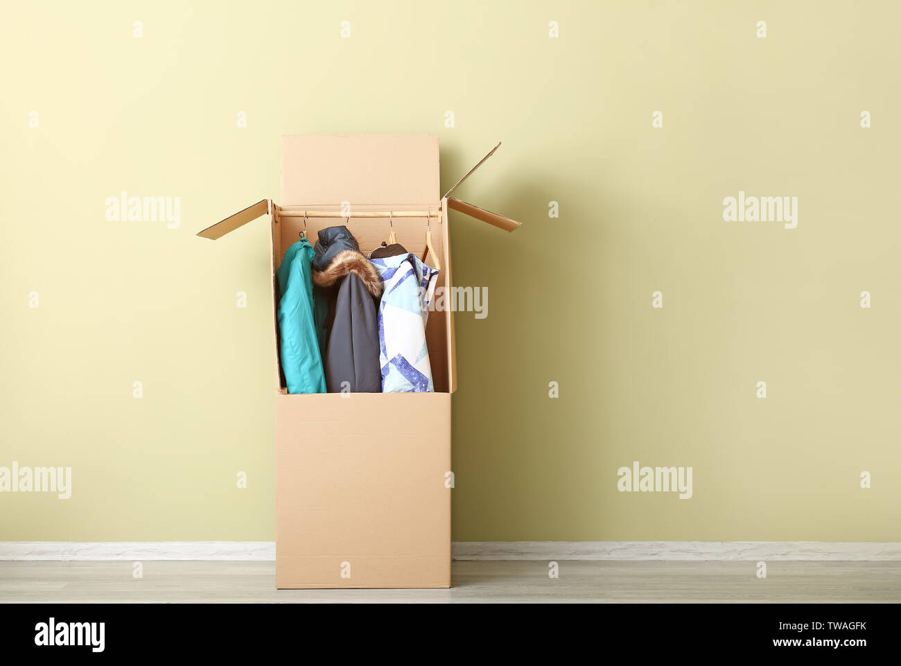 Wardrobe Box With Clothes Near Color Wall Stock Photo 256544055