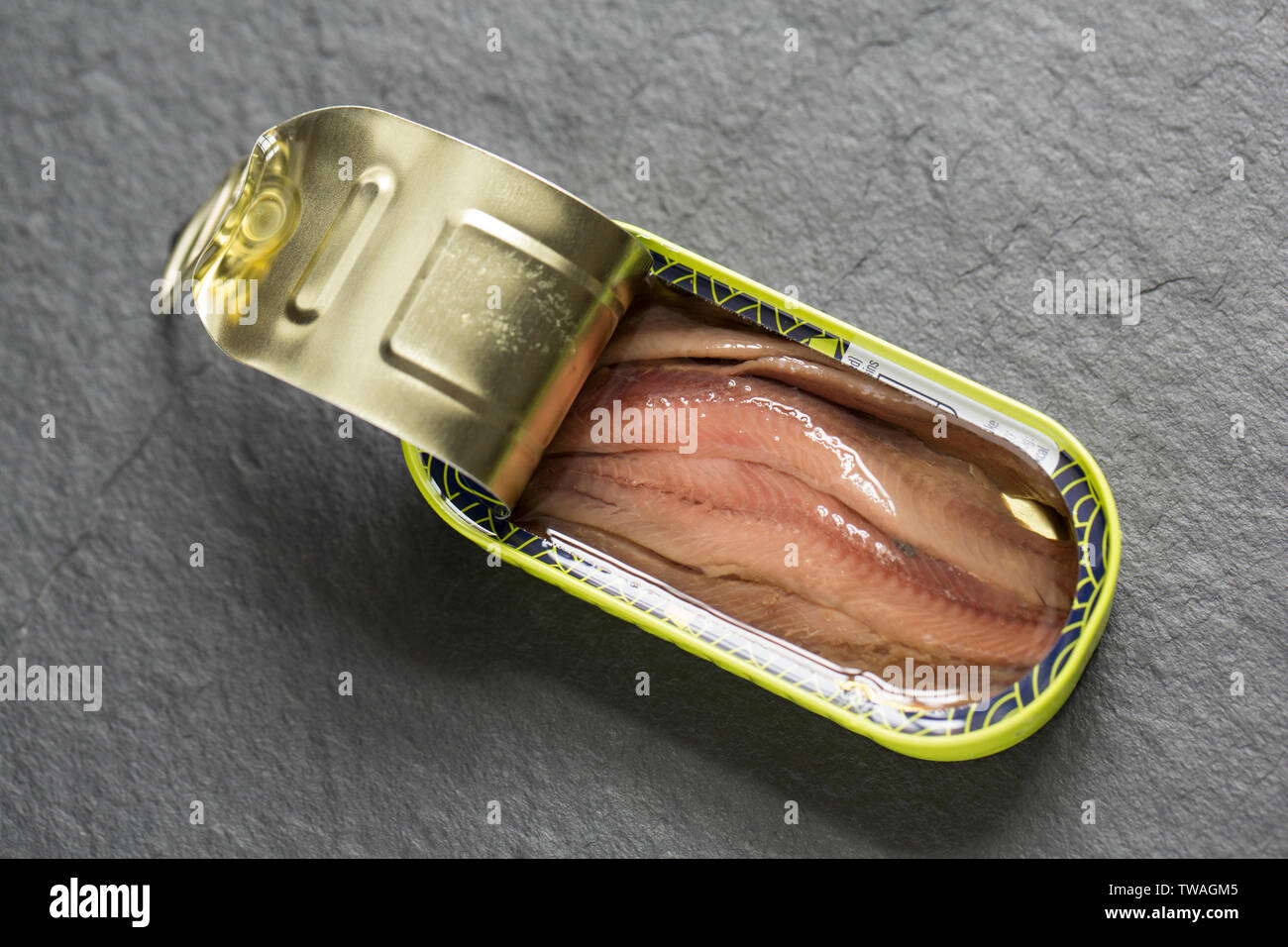 An opened tin of anchovy fillets from anchovies caught in the south
