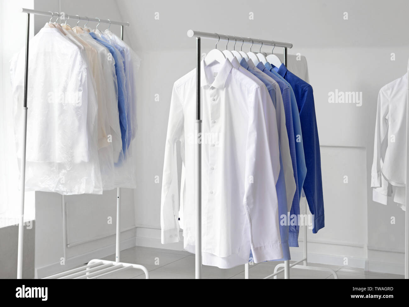 Racks with clothes after drycleaning indoors Stock Photo Alamy