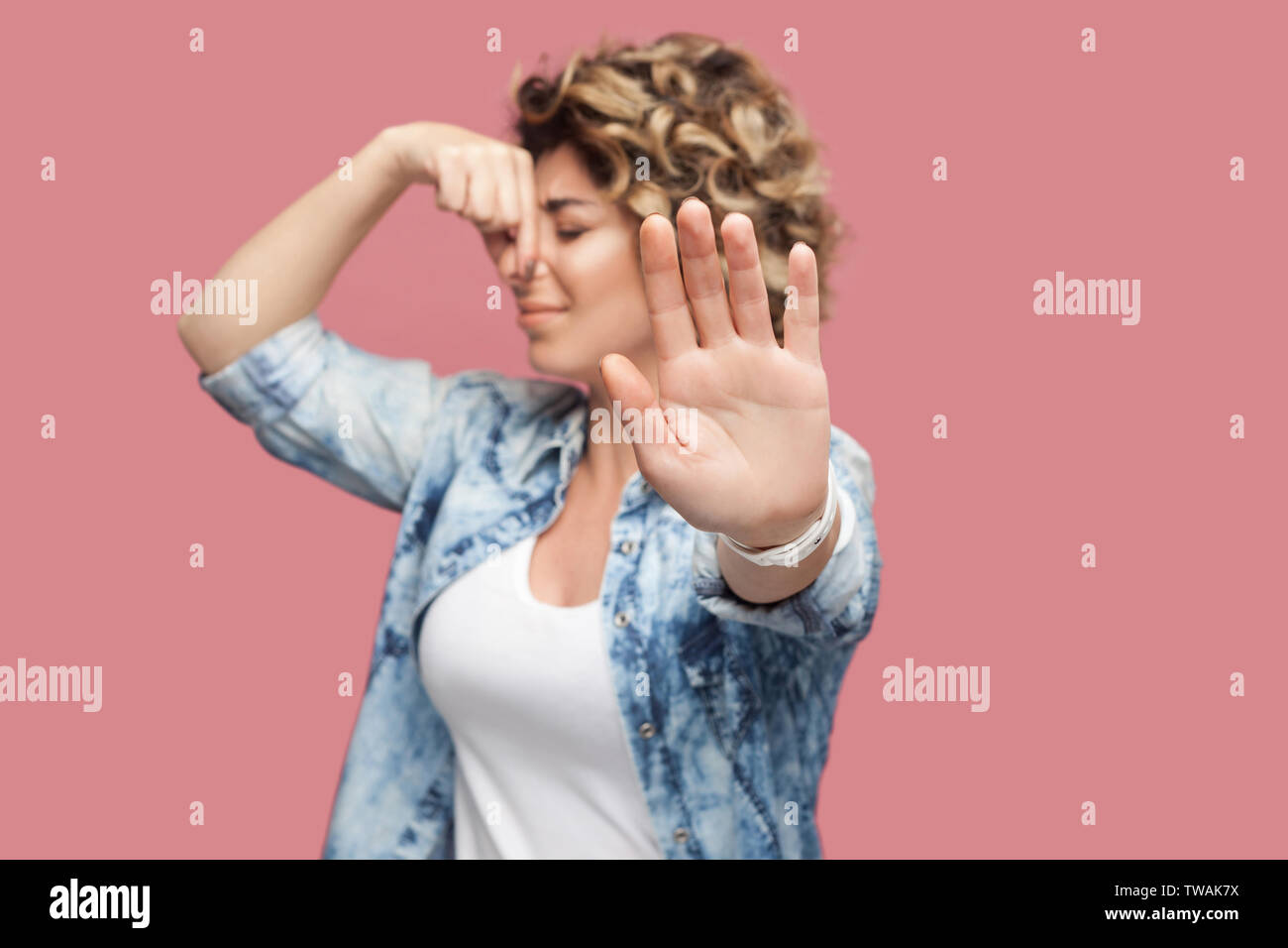 Bad Smell Blocking Portrait Of Dissatisfied Young Woman With