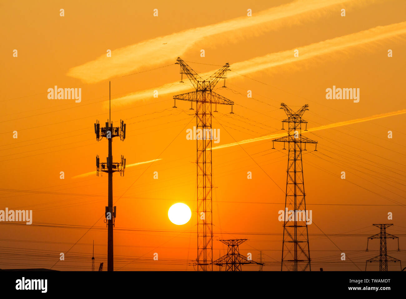 A transmission tower in the sunset Stock Photo - Alamy