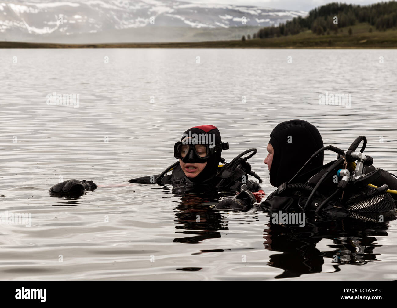 scuba diving in a mountain lake, practicing techniques for emergency