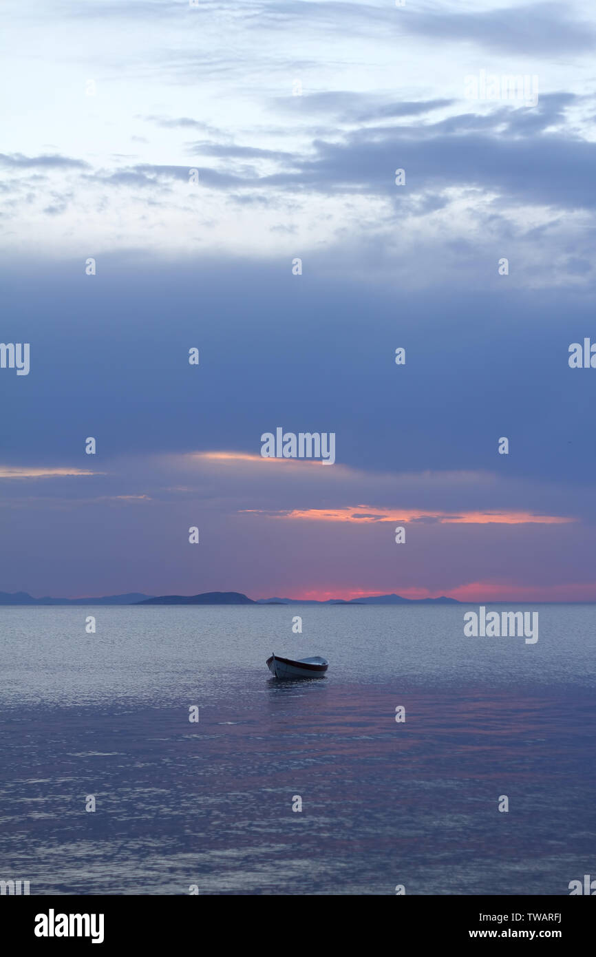 Sunset in the sea with a boat. A picture of a small boat with a ...