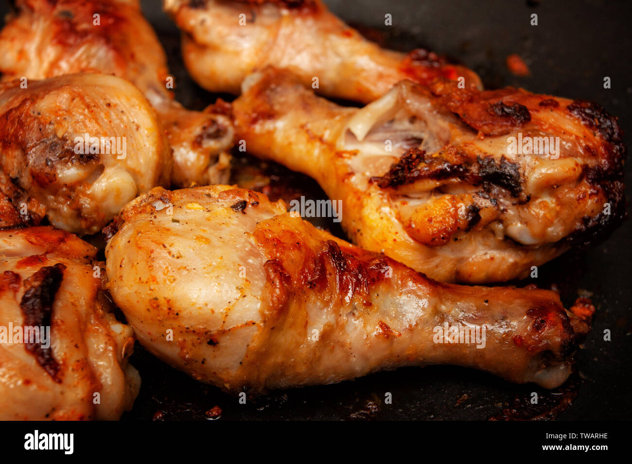 Roasted chicken legs in a pan Stock Photo