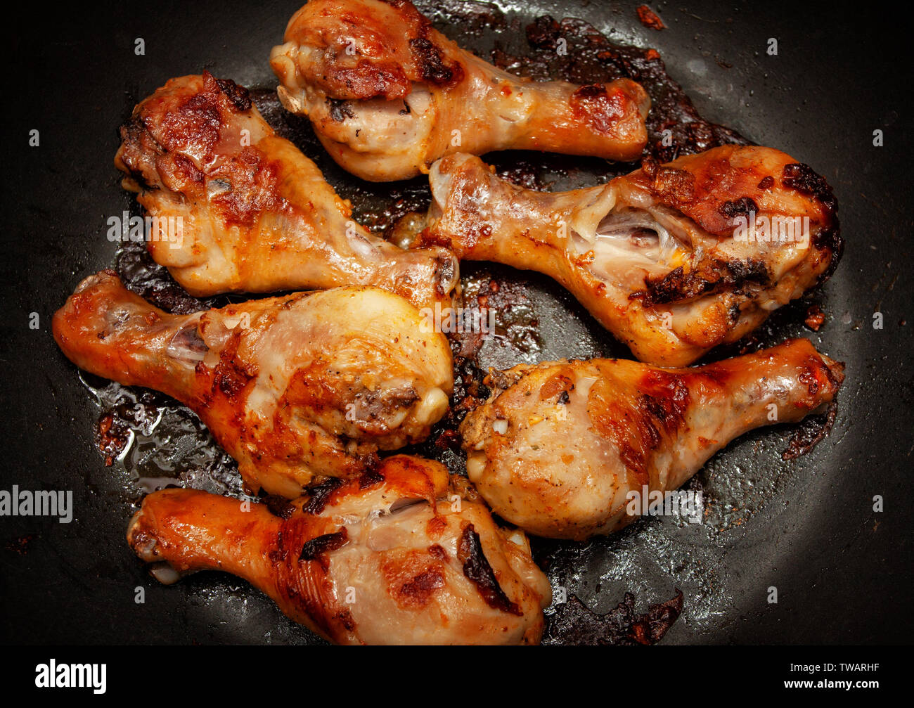 Roasted chicken legs in a pan Stock Photo
