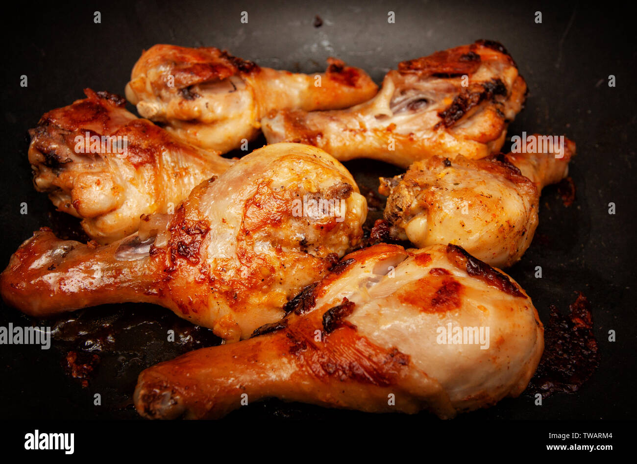 Roasted chicken legs in a pan Stock Photo