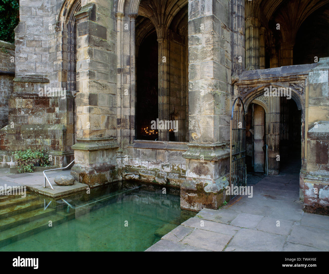 Healing well and bathing pool outside the lower chapel with star-shaped inner bath in the crypt of St Winifred's Chapel, Holywell, Wales. Stock Photo