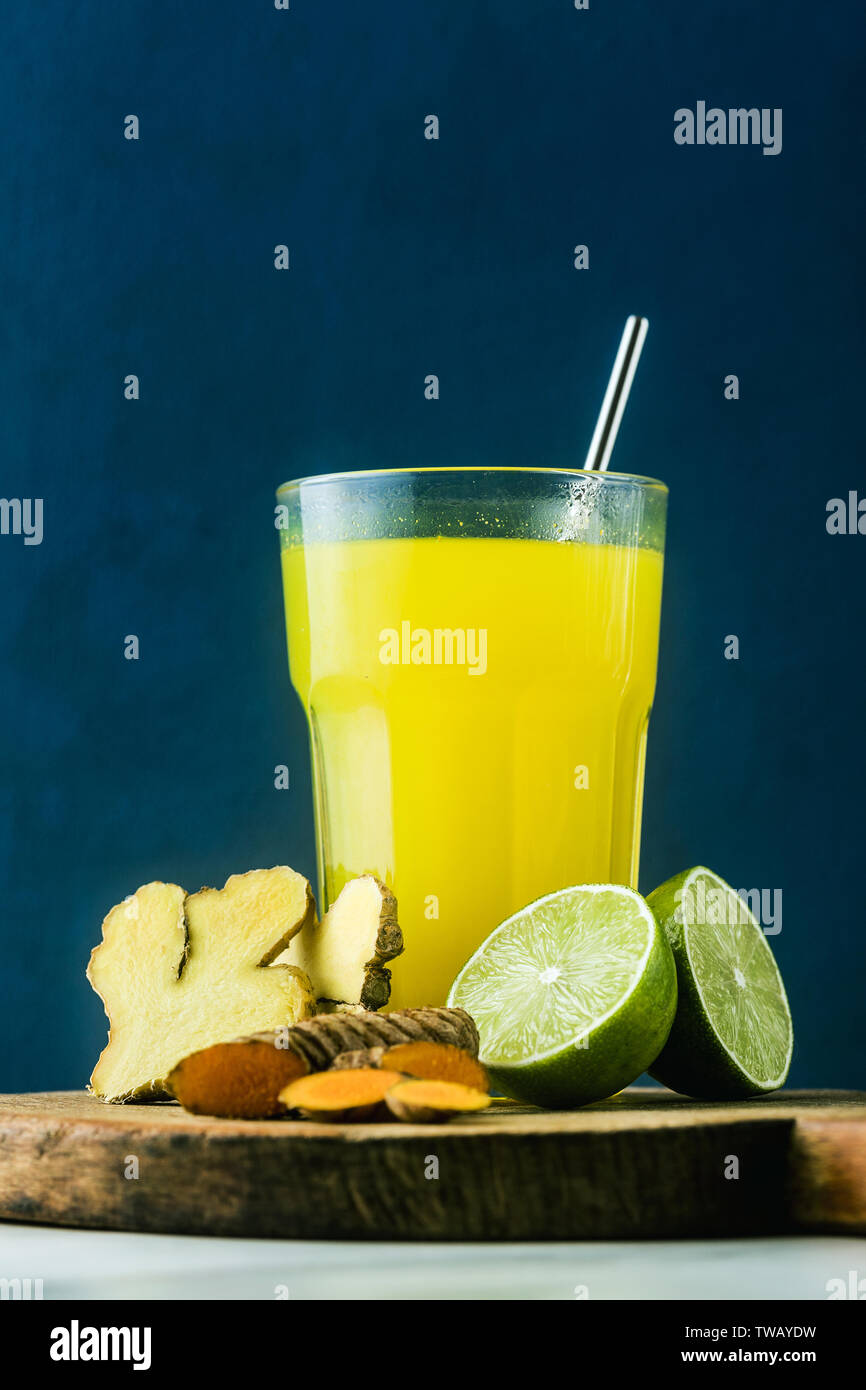 golden ginger and turmeric drink with lime juice. Healthy anti