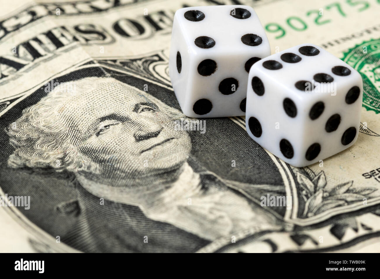 Playing dice on dollar american banknote Stock Photo Alamy
