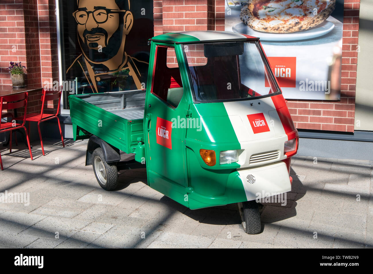 Piaggio Ape vehicle in front of Pizzeria Luca in Zsar Outlet Village in Vaalimaa, Finland Stock Photo