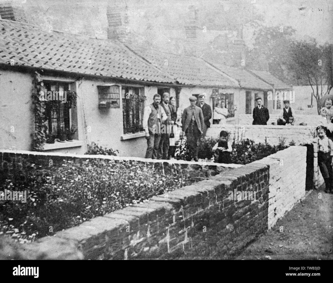 People Outside A Row Of Cottages East London Date Circa 1900