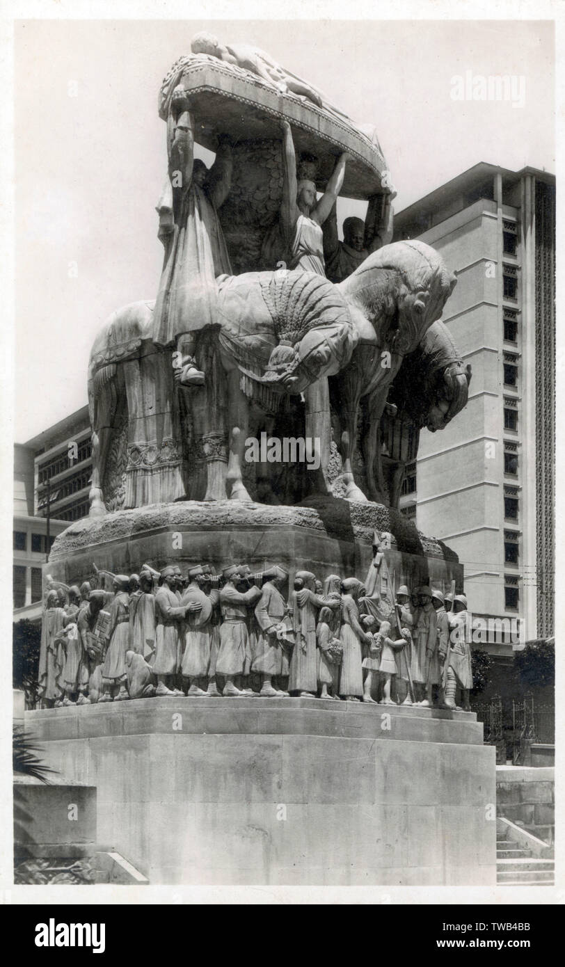 Algiers, Algeria - Architects Maurice Gras and Edouard Monestes - Sculptors Paul Landowski's (with bas-reliefs on the base carved by Bigonet) - Monument of the Dead (of WW1). In the late 1970s, the mayor of Algiers appointed Mhamed Issiakhem, one of the founders of Algerias modern art movement, to hide this remnant of colonialism. Not wanting to remove or destroy the statue, the artist decided to enclose it in a sort of concrete sarcophagus.     Date: circa 1930 Stock Photo