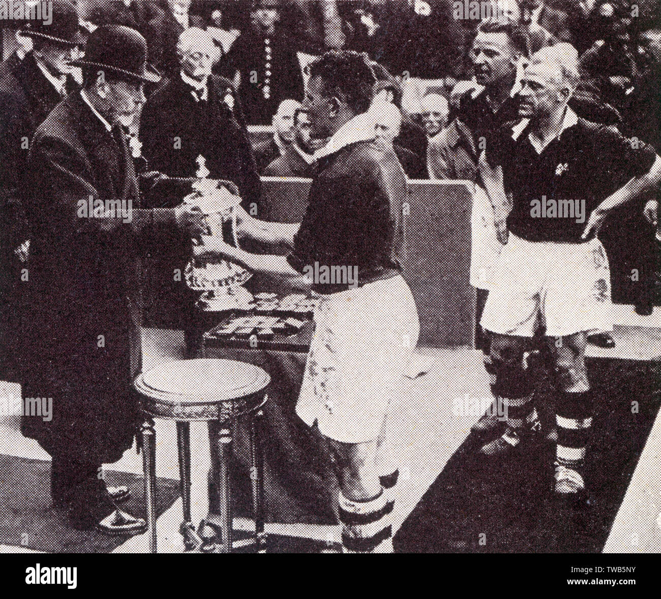 FA Cup Final 1934 - Cup presented to Sam Cowan, the captain of winners Manchester City FC by King George V. Man City defeated Portsmouth 2-1 on 28 April.     Date: 1934 Stock Photo