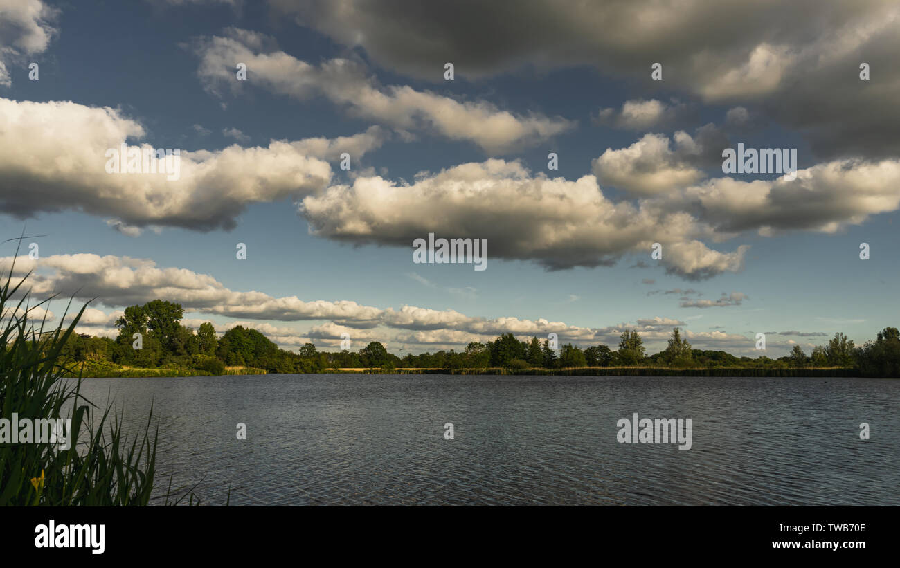 Serene landscape, fluffy clouds by the water Stock Photo