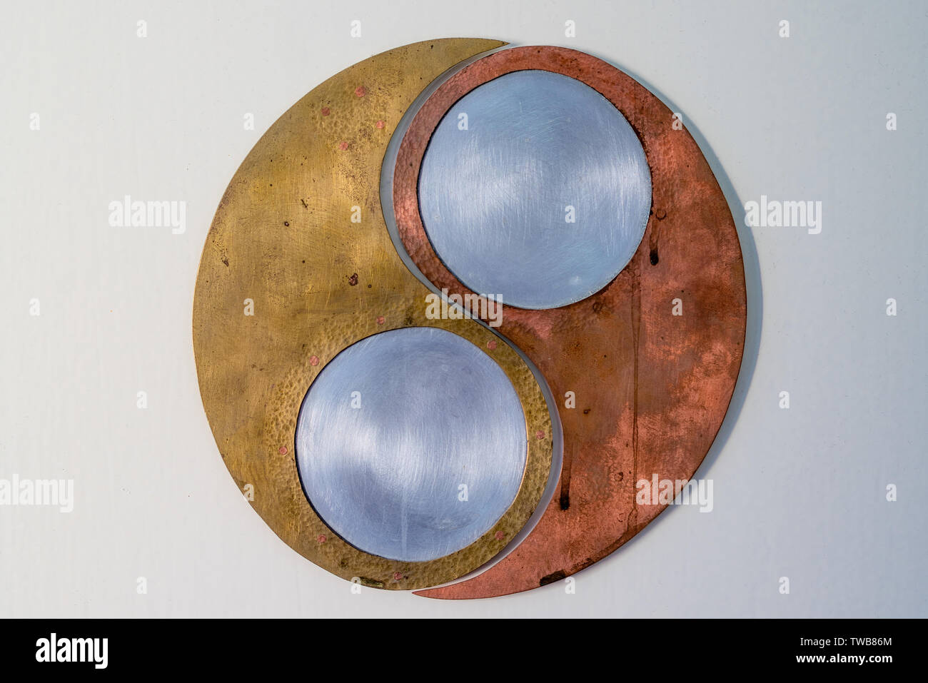 ying yang symbol hand made of copper, brass and steel Stock Photo