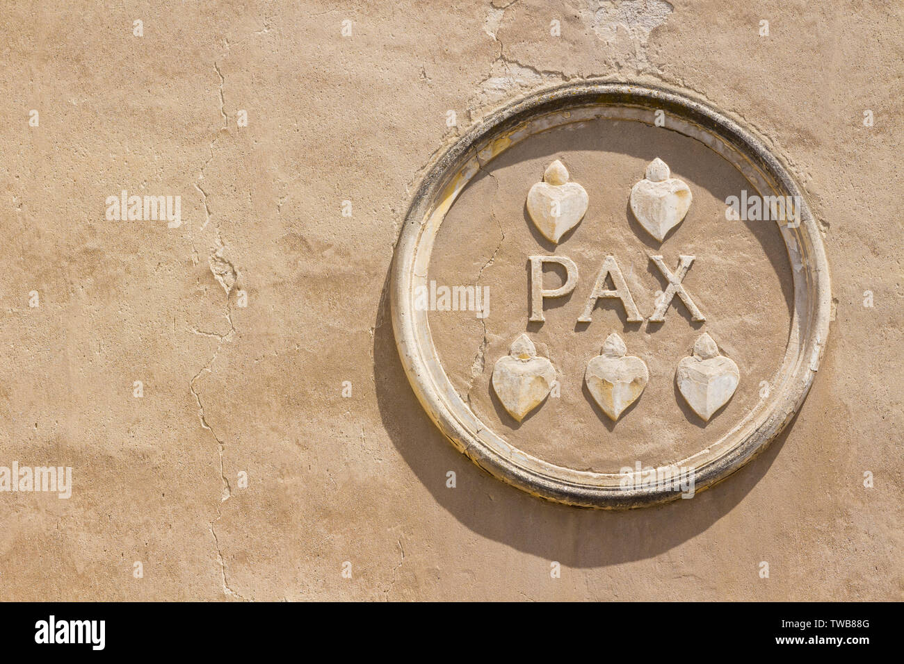 Pax (Peace) caption word in stone circle frame on the wall of St. James' Church built in the 14th-15th century, Koszeg, Hungary Stock Photo