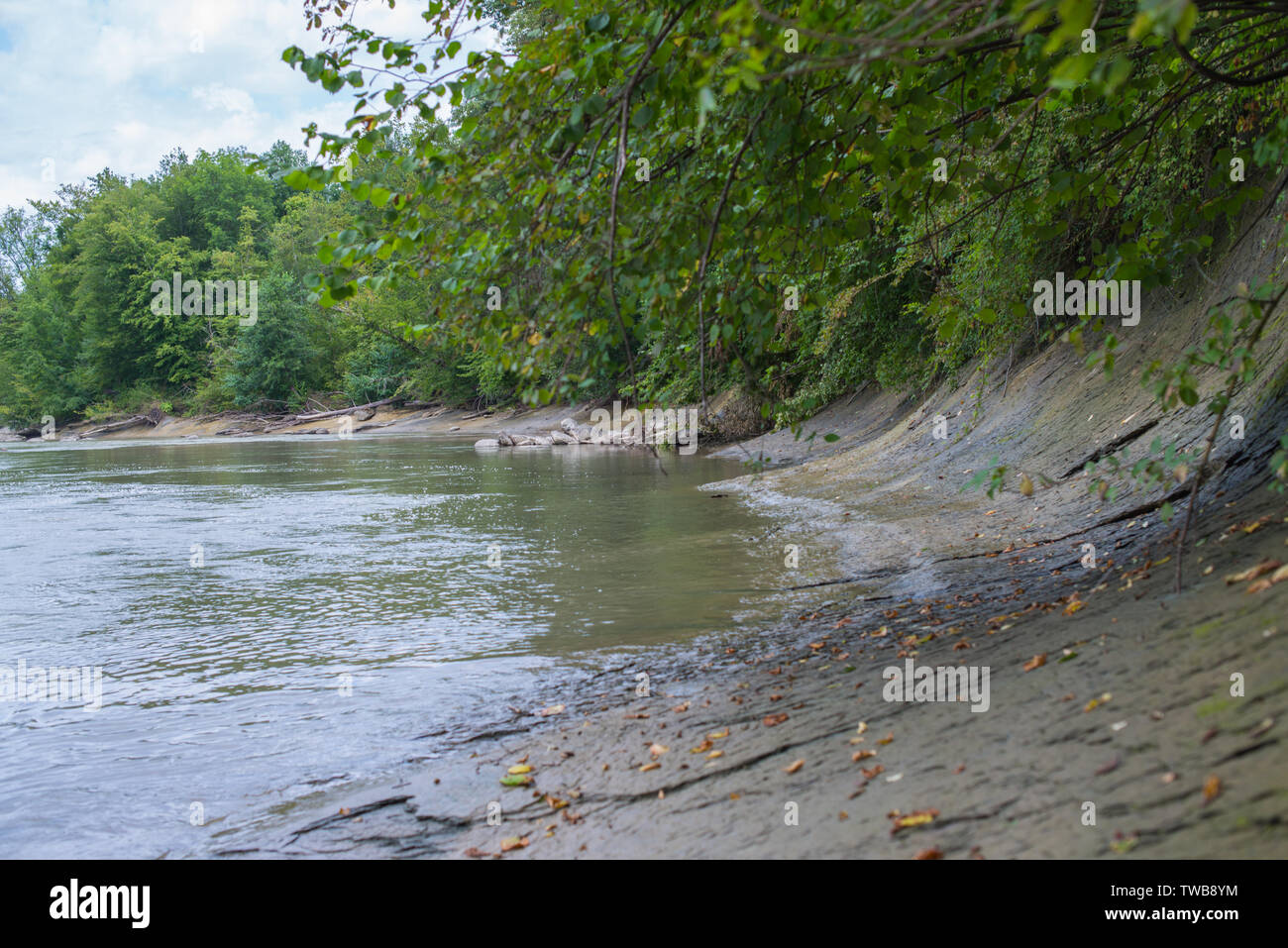 Sloping stony bank of a mountain river. Selective focus. Stock Photo