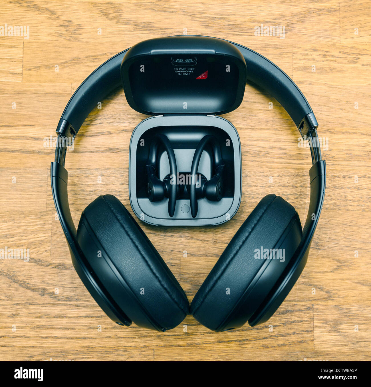 Paris, France - Jun 17, 2019: Square image Beats Studio 3 Wireless and Powerbeats Pro Beats in by Dr Dre in charging case wireless high-performance earphone with integrated Siri - directly above view Stock Photo