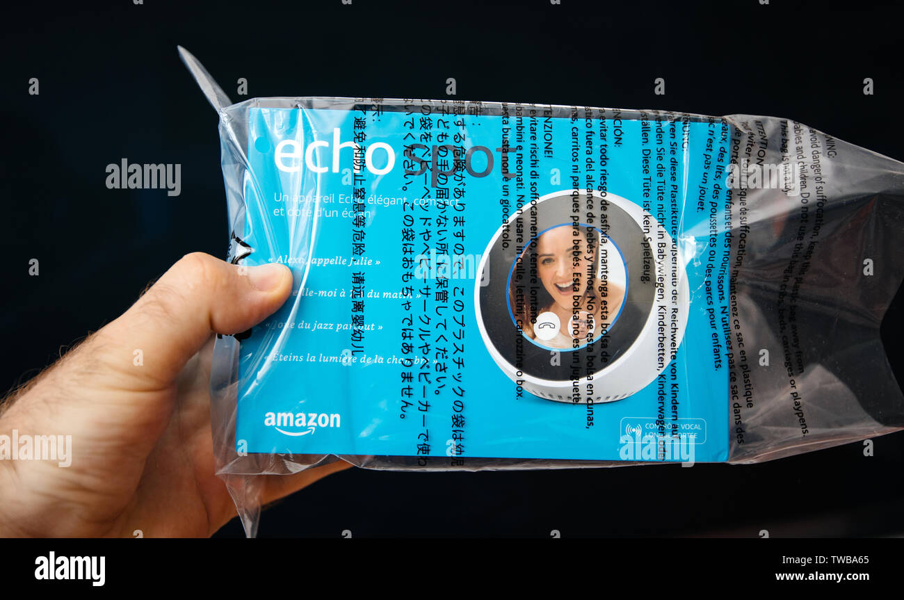 Paris, France - Jun 7, 2019: Man hand holding new Amazon Alexa Echo Spot in  plastic package with personal assistant Alexa with large display the brand  of smart speakers developed by Amazon