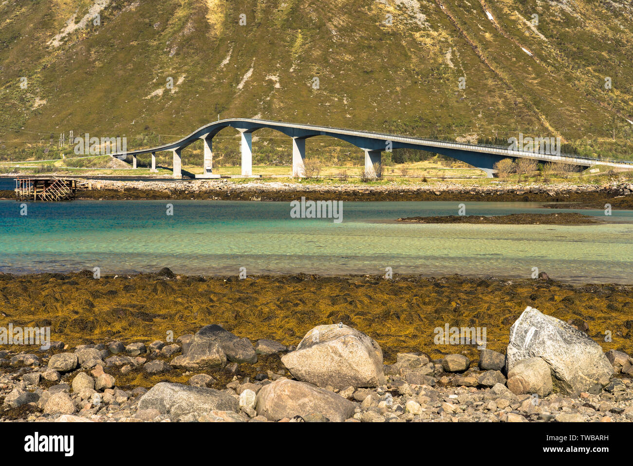 Elegant road bridge, Lofoten Islands,Norway crossing the turquoise clear water of a fjord Stock Photo