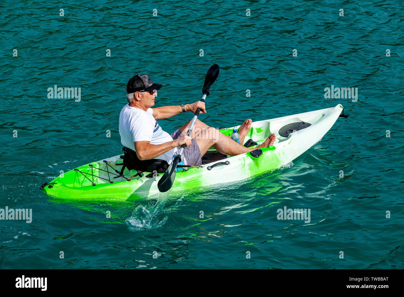 A Senior Male Kayaking At Otehei Bay, The Bay Of Islands, North Island, New Zealand Stock Photo
