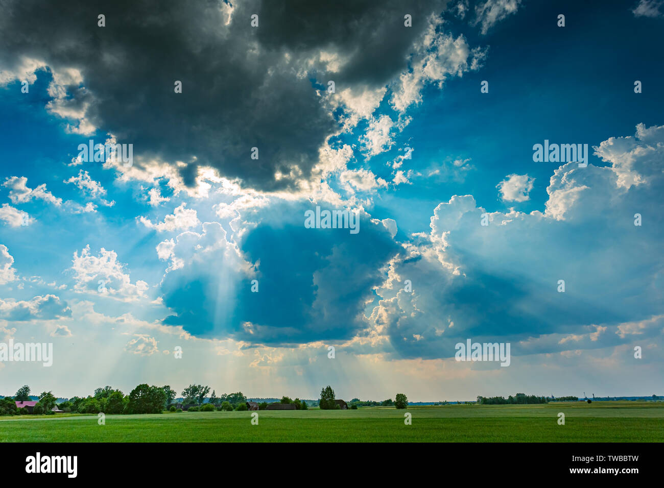 Cumulus storm clouds with light rays running across the sky Stock Photo